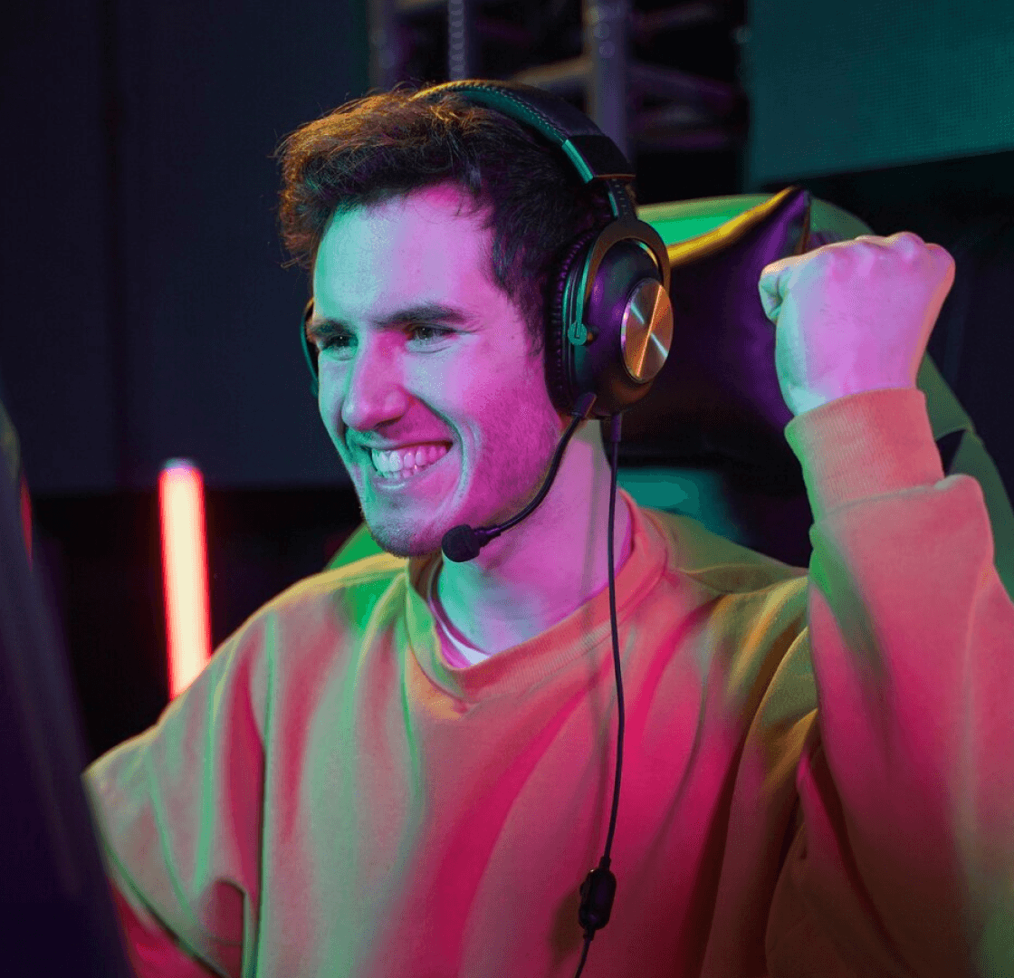 User wearing headphones and cheering on his winning